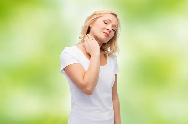 Unhappy woman suffering from neck pain