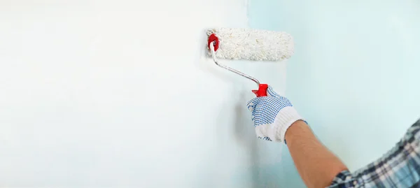 Close up of male in gloves painting wall