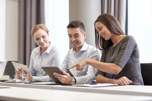 Smiling business people with tablet pc in office