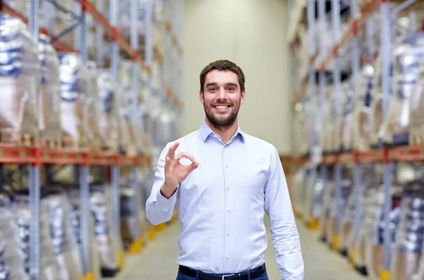 Happy man at warehouse showing ok gesture