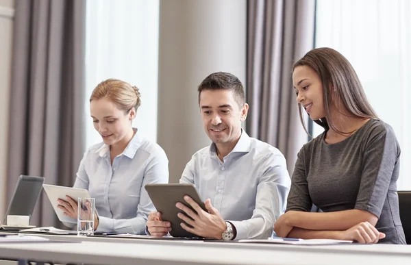 Smiling business people with tablet pc in office