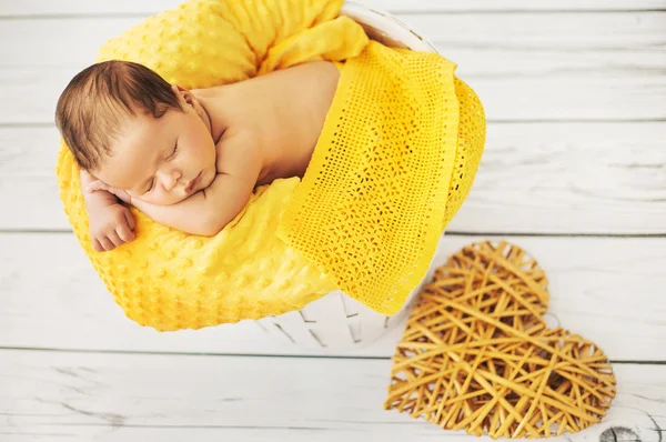 Cute baby sleeping on a yellow blanket