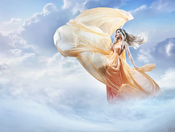 Dreamy image of a beautiful young lady in the clouds