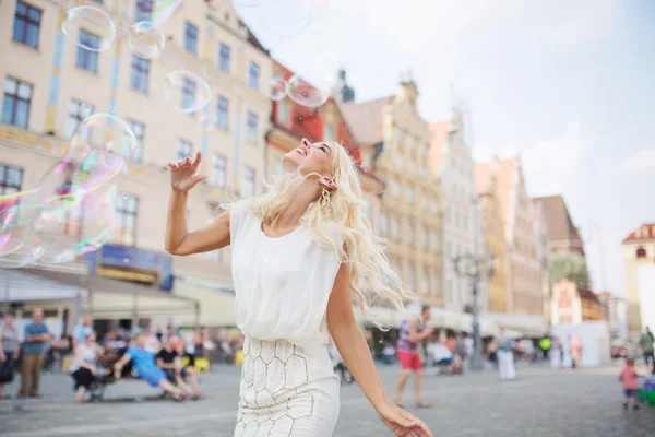 Alluring blonde having a grat fun with the soap bubbles