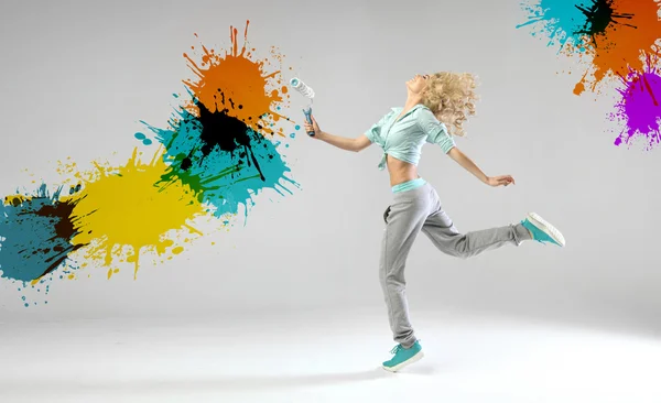 Conceptual photo of a woman painting walls