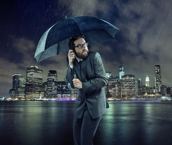 Afraid businessman in the rain