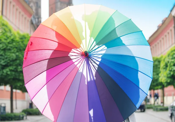 Couple hugging behind the umbrella