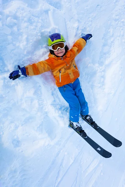 View from above of little boy in ski mask