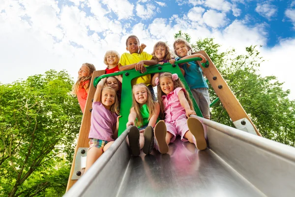 Many kids on playground chute
