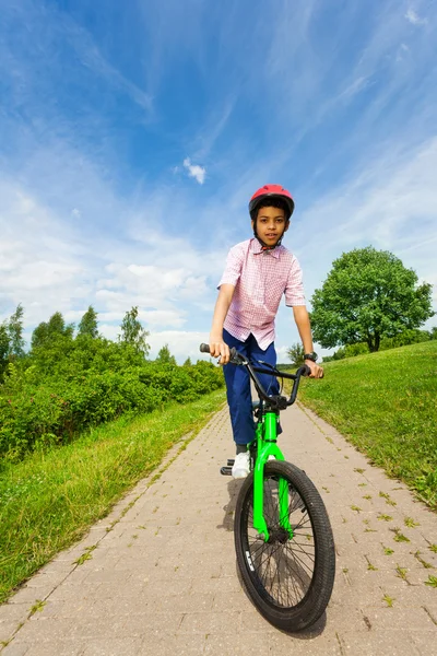 African boy rides bike