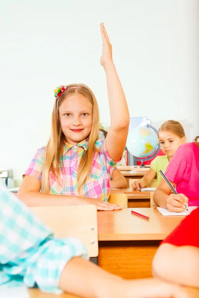 Blond girl holds hand up