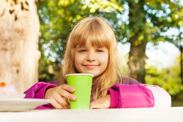 Blond girl with green cup