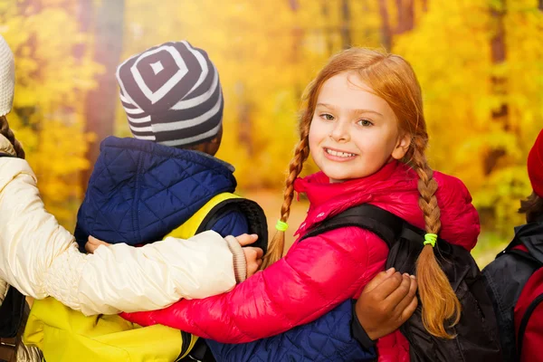 Kids group standing close with rucksacks