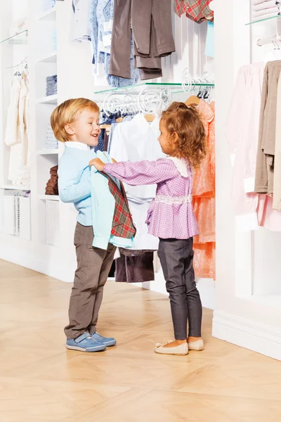Girl and boy in clothes store
