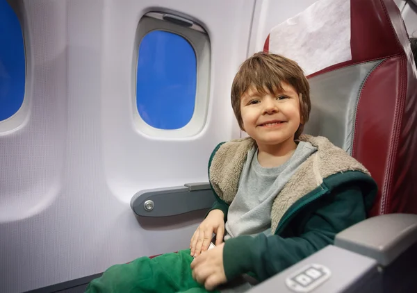 Boy sits in commercial jet plane
