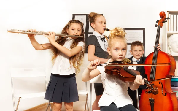 School children play musical instruments