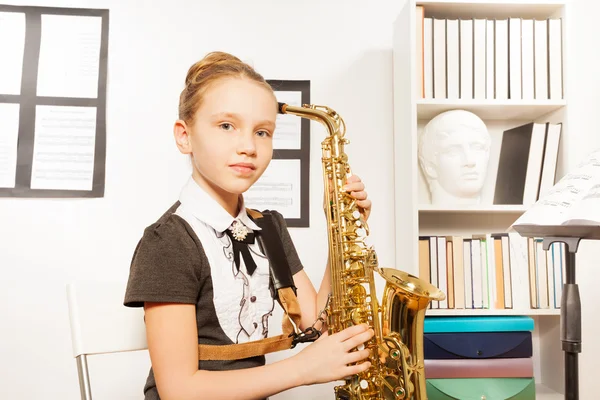Girl in dress with alto saxophone