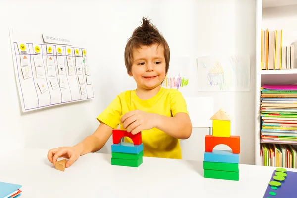 Smiling boy replicating example with blocks