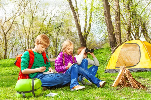 Happy children resting near bonfire