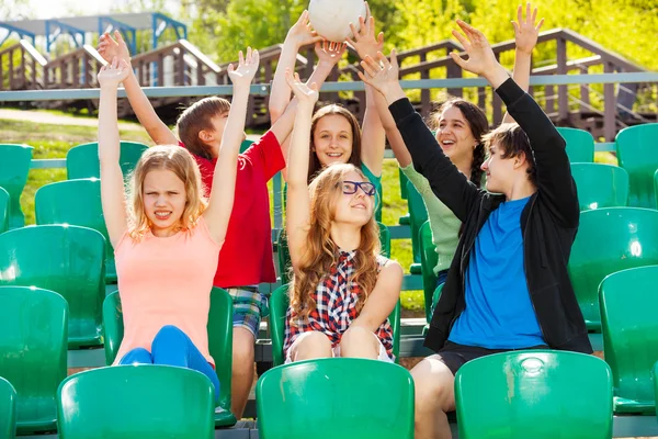 Teens hold ball at tribune