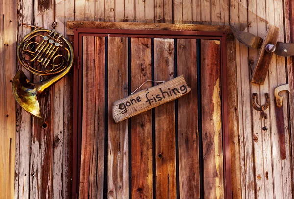 Gone fishing sign on old door