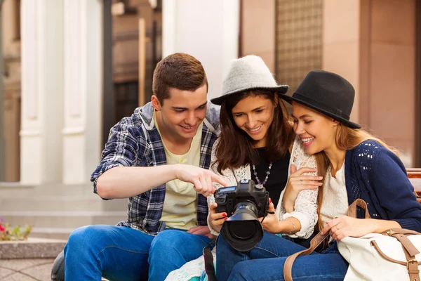 Guy and girl with camera sitting