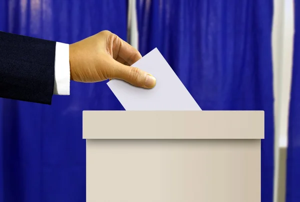 Person hand casting a vote