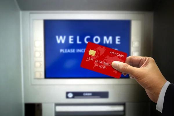 Hand Holding ATM Card at ATM machines