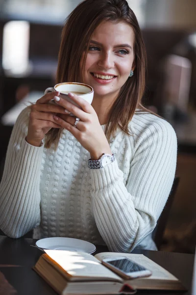 Blonde woman holding cup of coffee