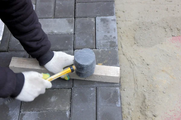 Installing paving slabs with a mallet