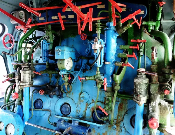Steam engine with pipes, tubes, and gauges