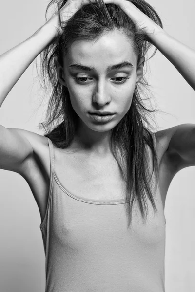 Portrait of beautiful fashion model posing over gray background.