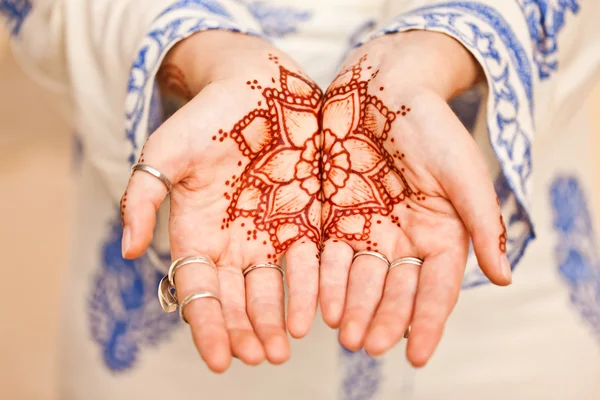 Mehndi tattoo. Woman Hands with black henna tattoos. India natio