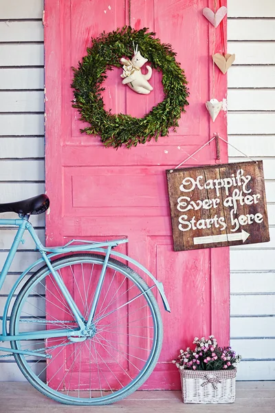 Valentine wreath and sign board on wooden vintage pink door