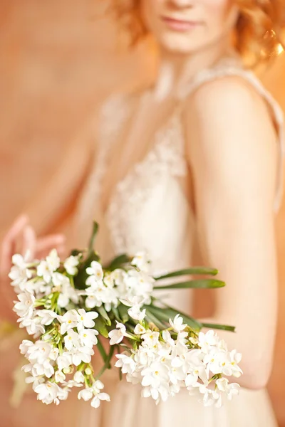 Tender beauty portrait of bride with flowers bouquet