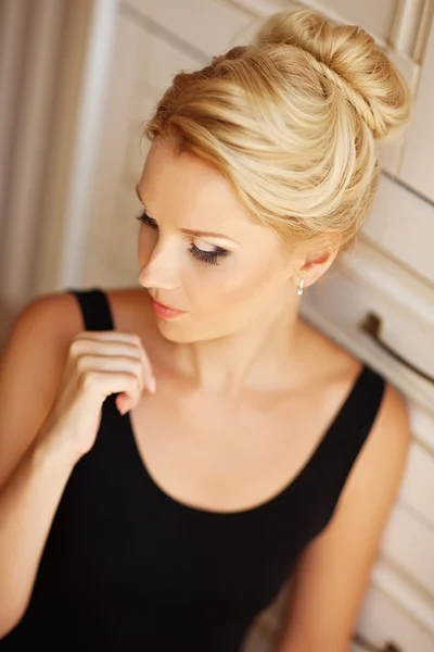 Portrait of a dreaming woman relaxing at home. Vintage interior.