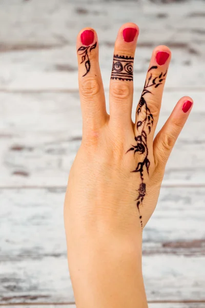 Woman Hand Painted with Black Henna Counting Numbers