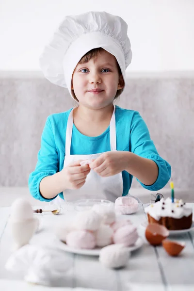 Little girl in a cap Chef