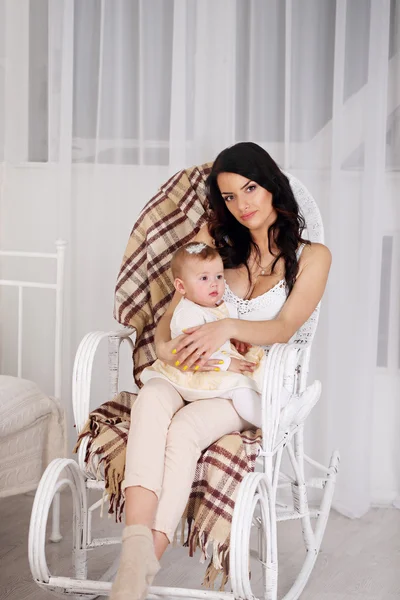 Portrait of mother and daughter in the rocking chair