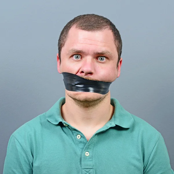 Kidnapped man with tape over his mouth