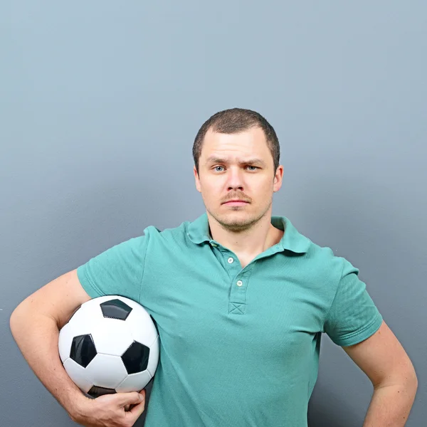 Portrait of man holding football - Football fan supporter or pla