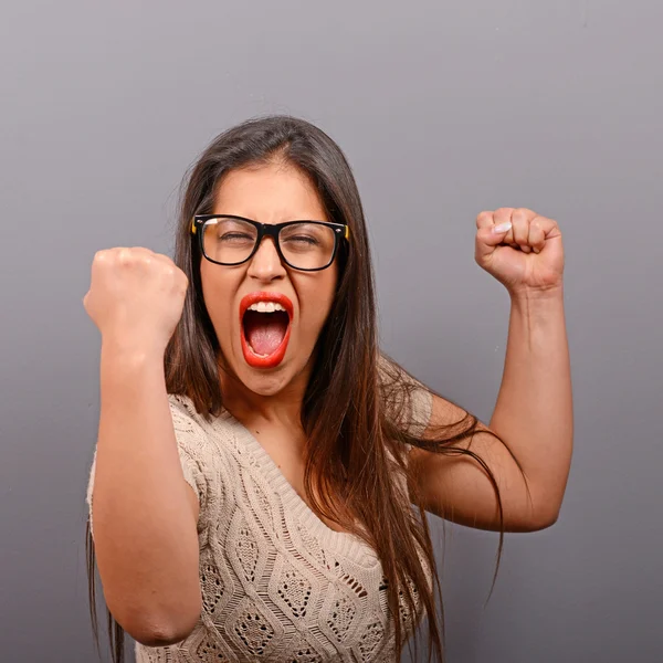 Portrait of happy woman exults pumping fists ecstatic celebrates