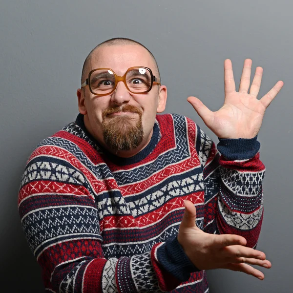 Portrait of a nerd clapping hands with glasses and retro sweater