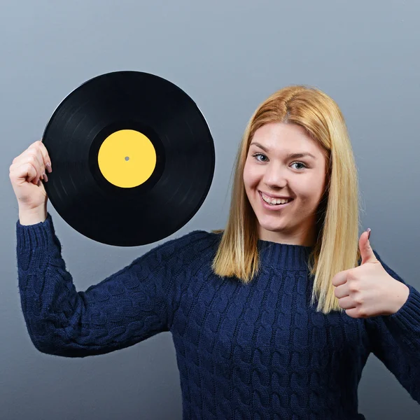 Woman dj portrait with vinyl record against gray background