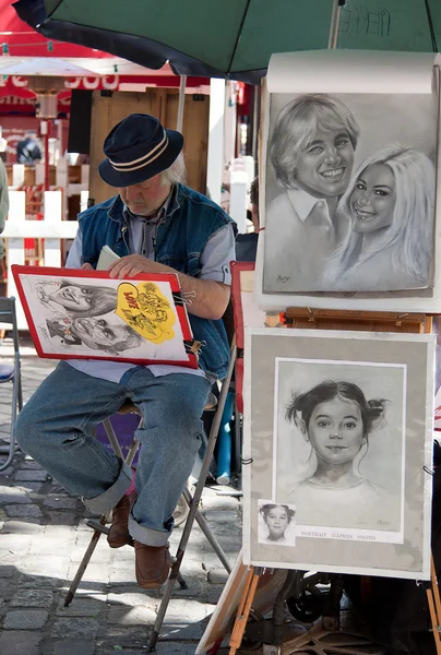 Parisian Artist Drawing a Caricature in Montmartre of Paris