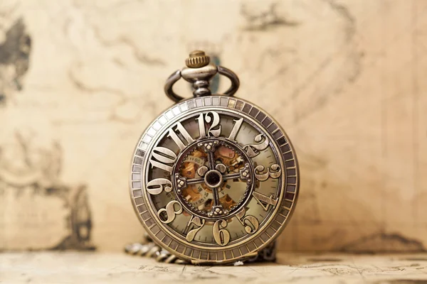 Pocket watch over antique map