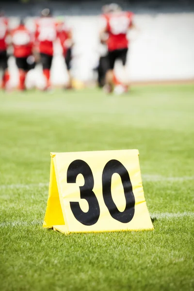 Football yard line with a sign