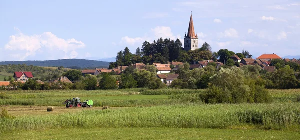 Panoramic rural landscape with village at sunset