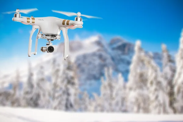 White drone quad copter with 4K digital camera flying.