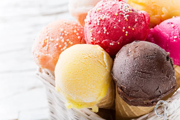 Ice cream scoops on wooden table.